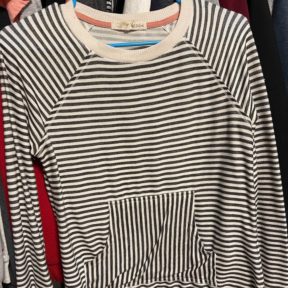 Cute long sleeved shirt. Not really a sweater but not super thin either